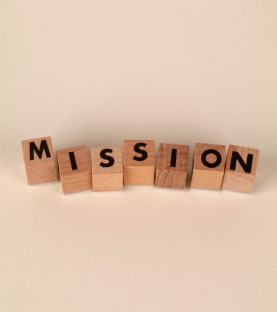 Wooden blocks with letters spelling 'Mission' on a soft neutral background, ideal for business themes.